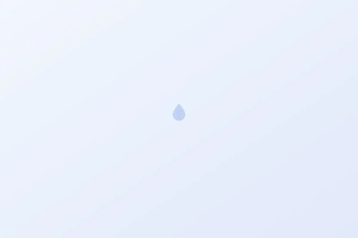 White salt pellets inside an open softener brine tank with a brine well